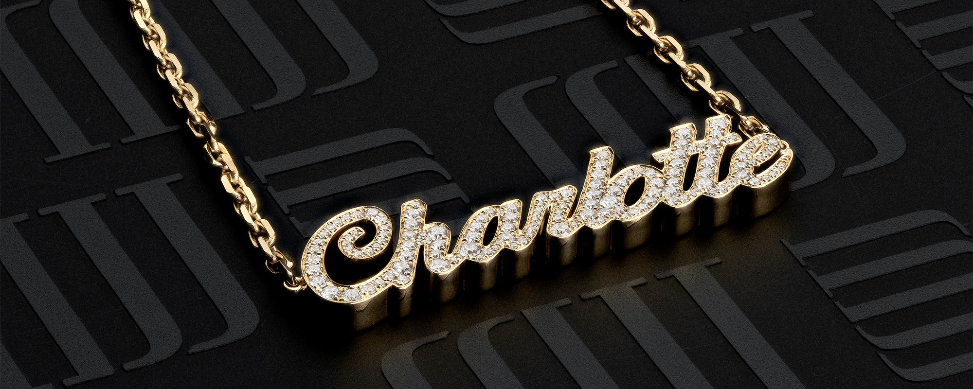 Gold bespoke name necklace by MJ Jones, featuring 'Charlotte' in diamond-encrusted script. This customisable pendant showcases luxury and personalisation, ideal for those seeking unique, high-quality personalised jewellery. Perfect as a meaningful gift or statement piece for fine jewellery enthusiasts.